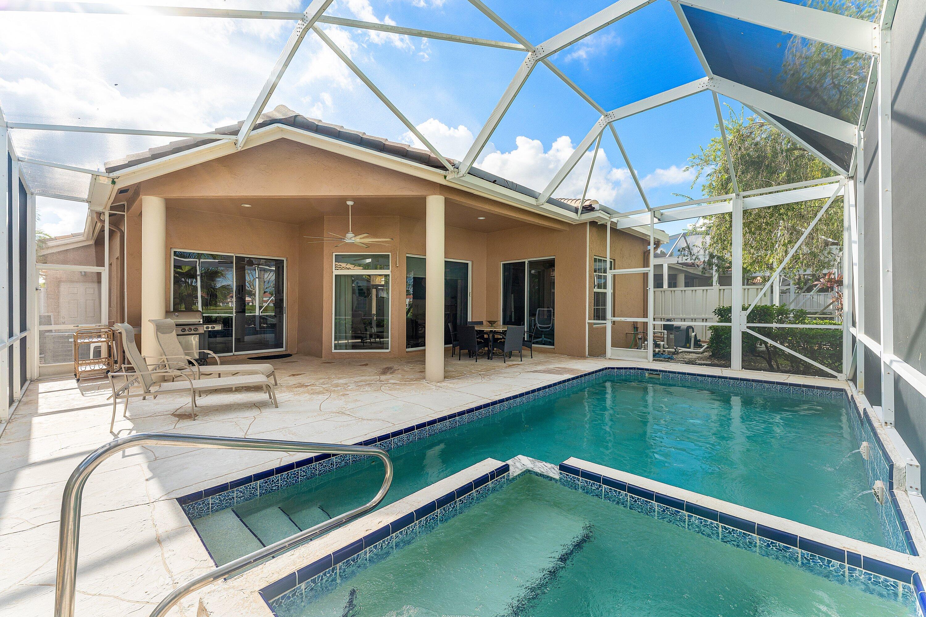 8217 Quail Meadow Way West Palm Beach, FL 33412 - Photo 7 of 38 a view of a backyard with a swimming pool