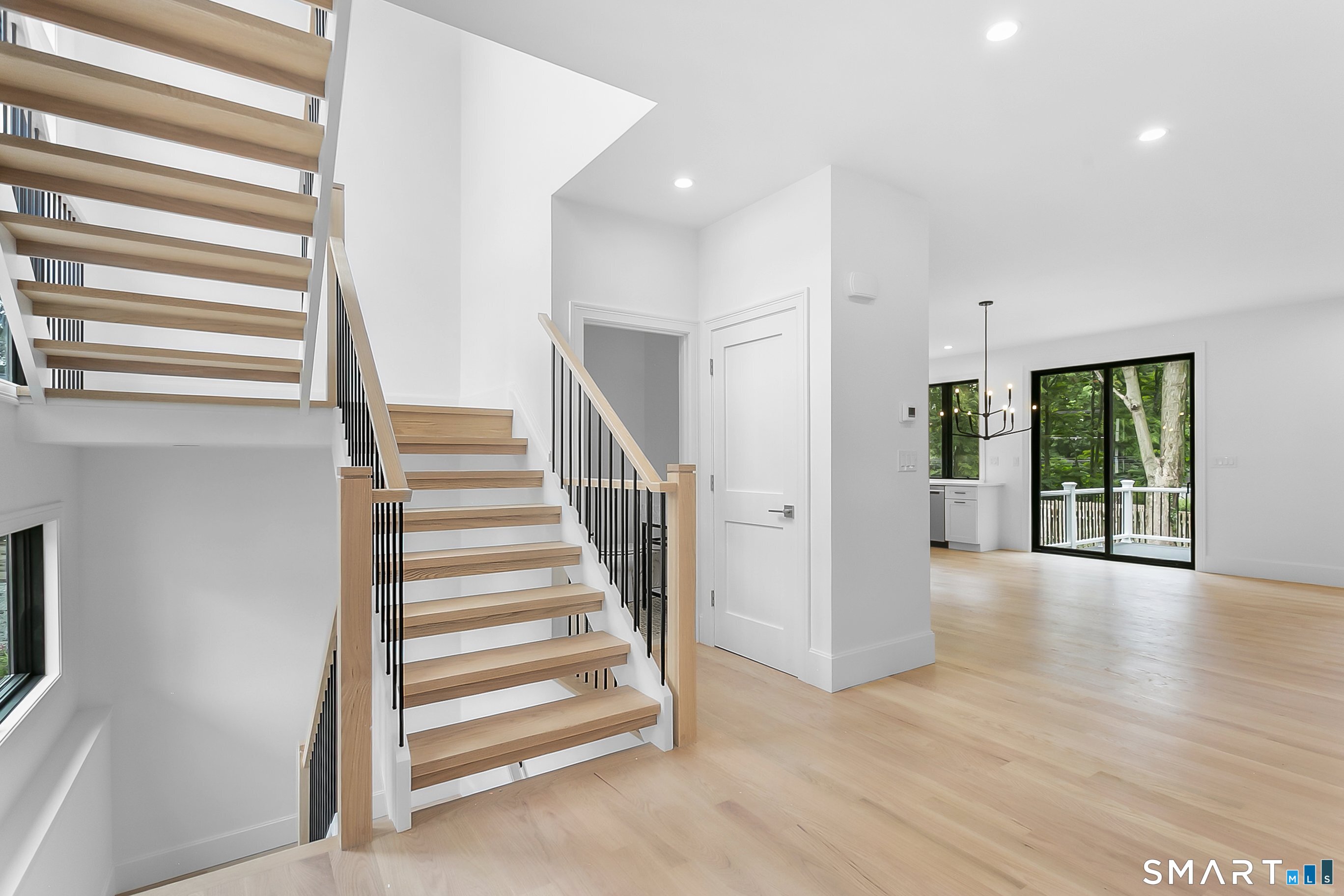 85 Oronoque Hills Road Stratford, CT 06614 - Photo 22 of 37 a view of a livingroom with wooden floor and stairs