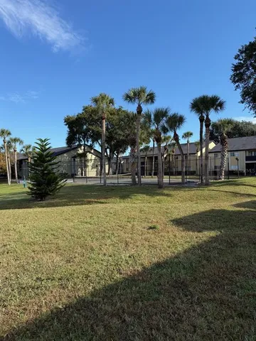 a house view with swimming pool in front of it