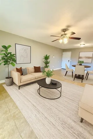 a living room with furniture and a potted plant
