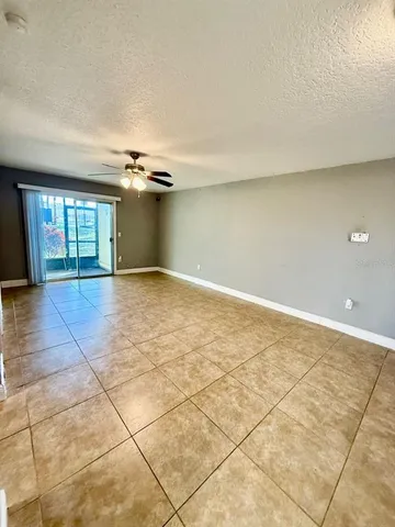 an empty room with a empty space and windows