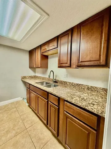 a kitchen with stainless steel appliances granite countertop a sink and cabinets