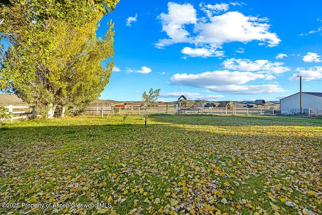 a dining room with furniture a rug and wooden floor