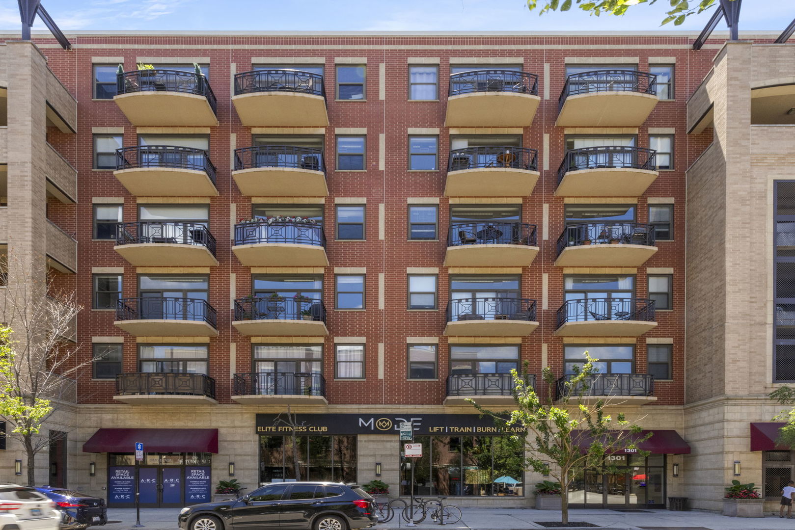 1301 West Madison Street, Unit 305 Chicago, IL 60607 - Photo 1 of 22 a front view of multi story residential apartment building