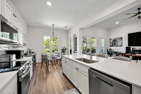 a kitchen with a sink appliances and a counter top space