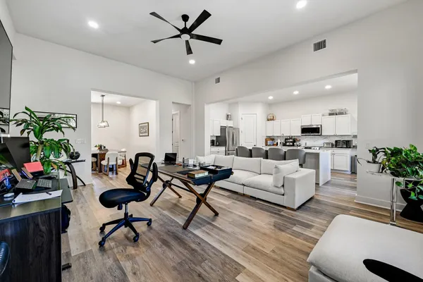 a living room with furniture and a potted plant
