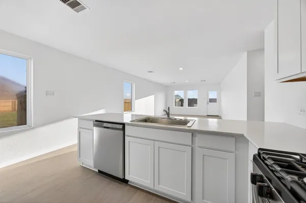a kitchen with granite countertop a sink and a stove