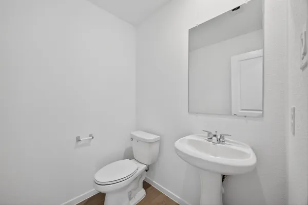 an empty room with an entryway and fan