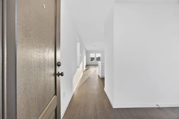 a view of a hallway with a wooden floors