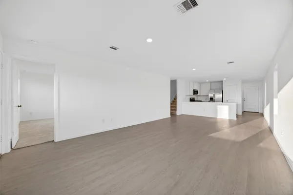 a view of kitchen and hall with wooden floor