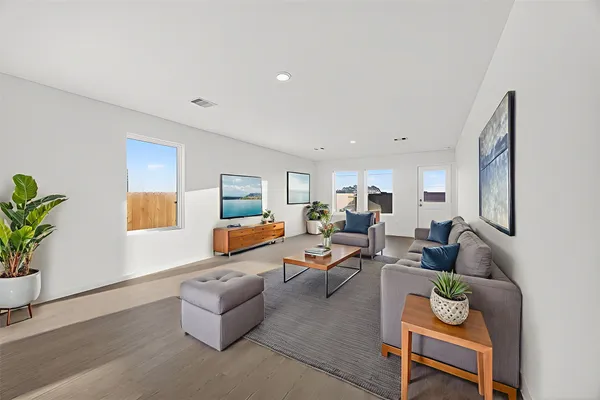 a living room with furniture and a potted plant