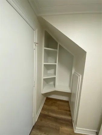 a view of a room with wooden floor