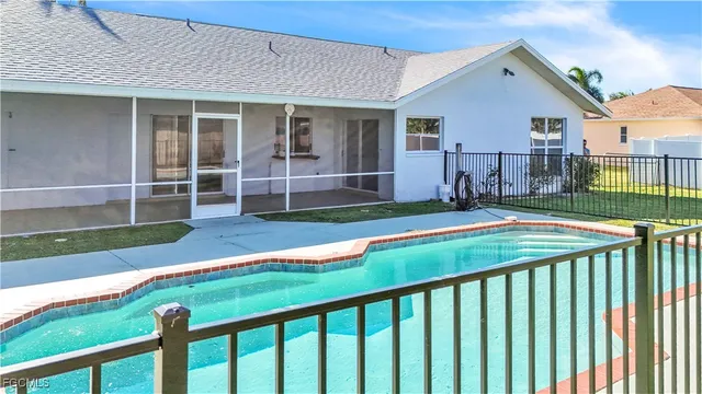 a view of a backyard with wooden fence