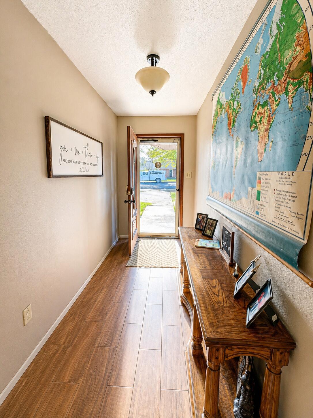 2023 Rice Drive Levelland, TX 79336 - Photo 3 of 15 a view of a hallway with furniture and wooden floor