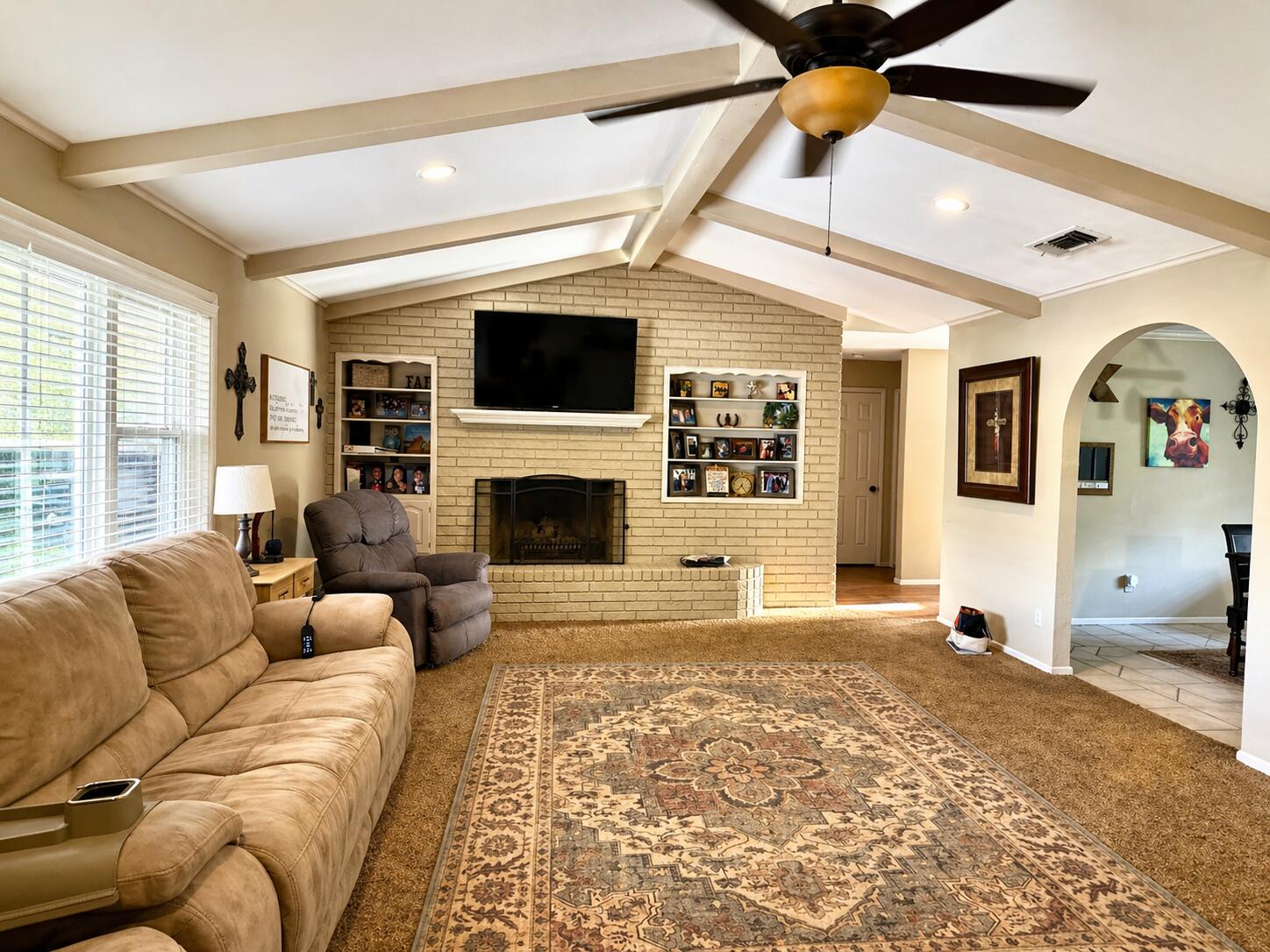 2023 Rice Drive Levelland, TX 79336 - Photo 5 of 15 a living room with furniture a fireplace and a flat screen tv