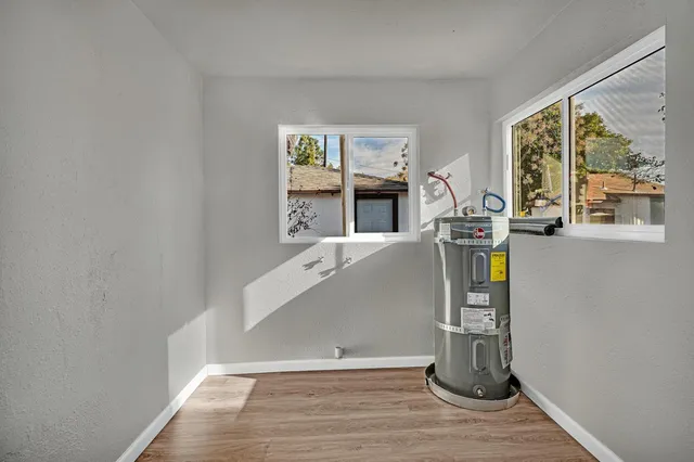 a kitchen with white cabinets a sink and dishwasher