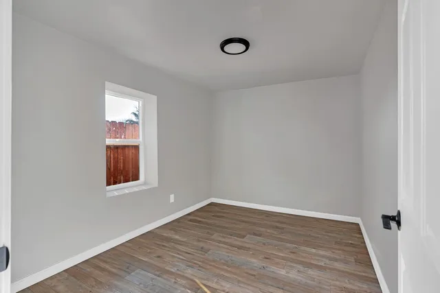 wooden floor with white walls