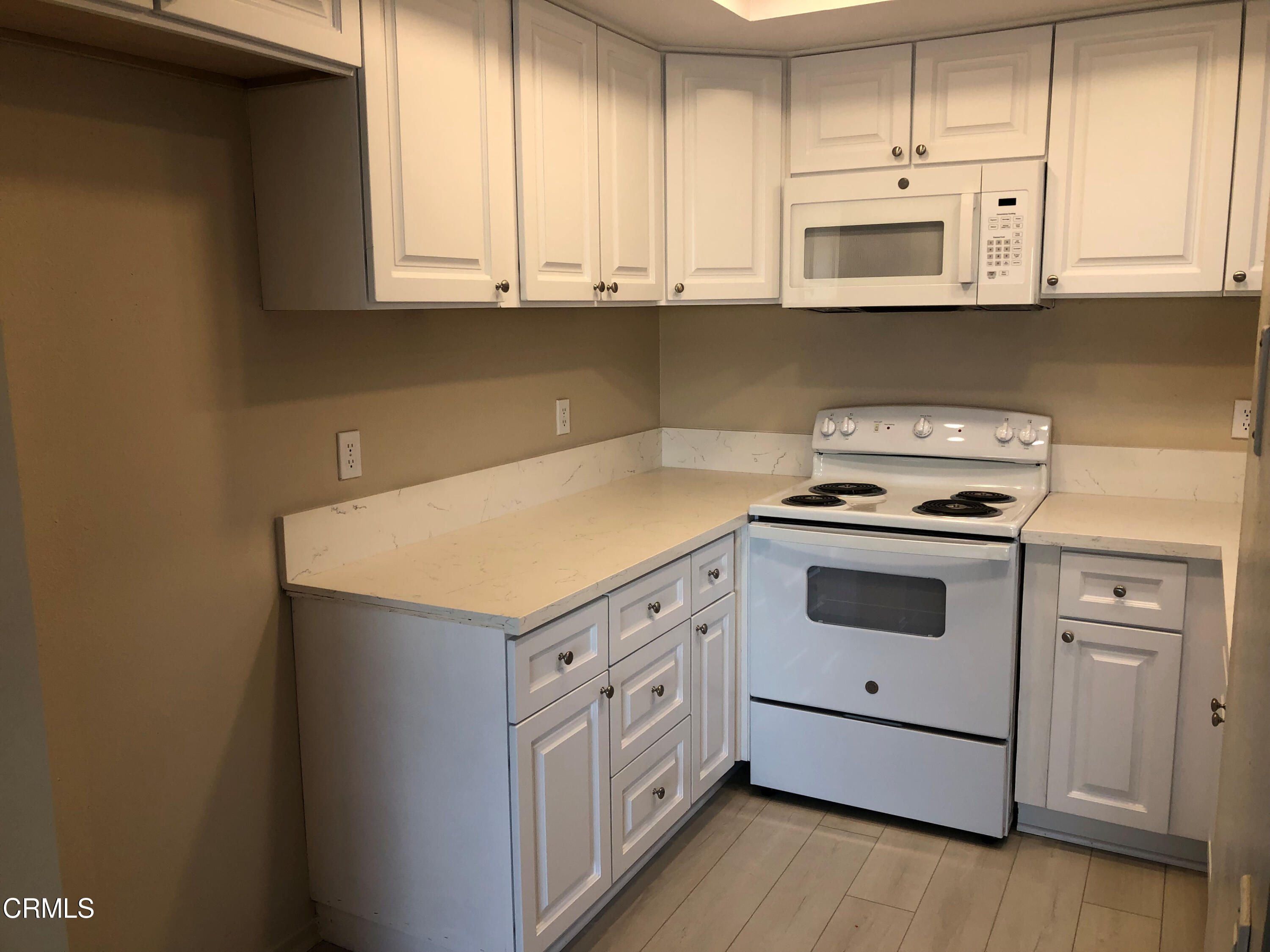 3134 Sunset Lane Oxnard, CA 93035 - Photo 9 of 21 a kitchen with granite countertop white cabinets and white appliances