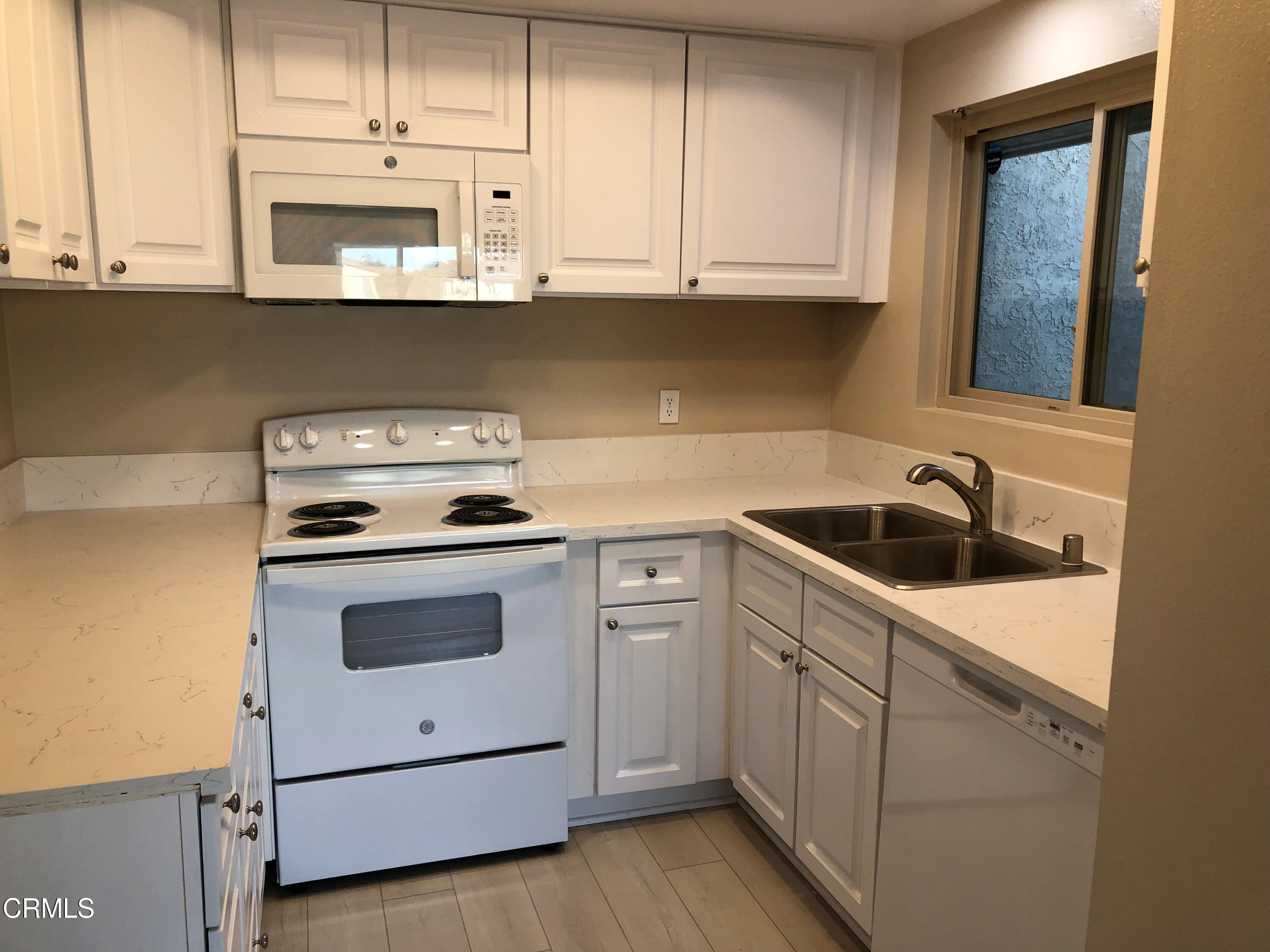 3134 Sunset Lane Oxnard, CA 93035 - Photo 10 of 21 a kitchen with white cabinets stainless steel appliances and sink