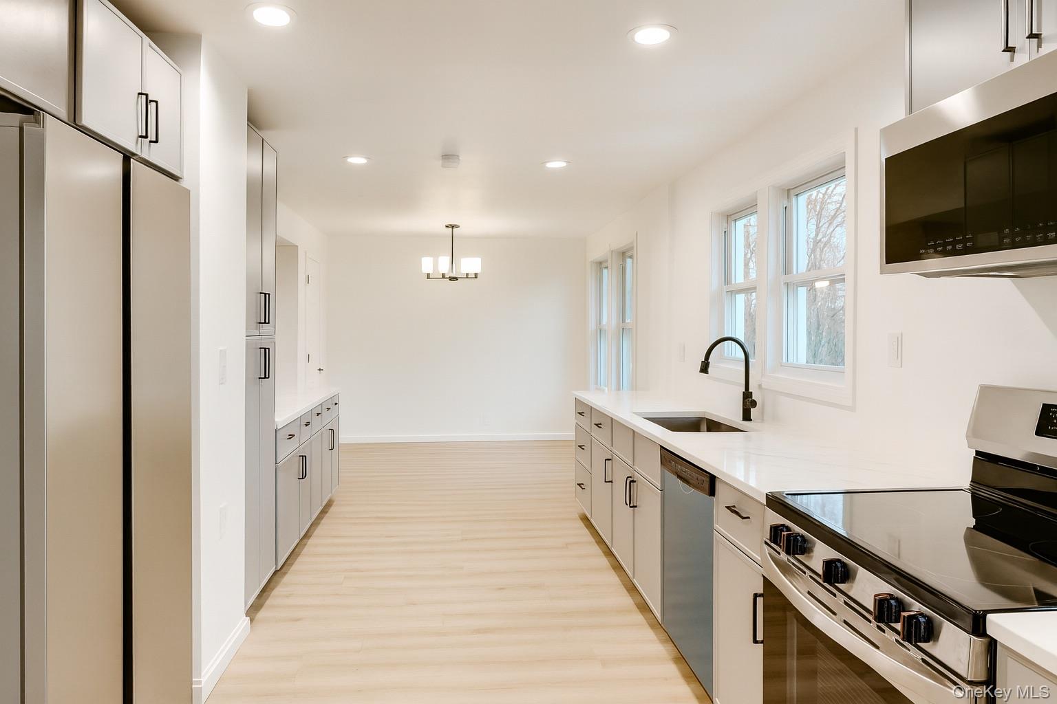 88 Cold Spring Road Liberty, NY 12754 - Photo 8 of 32 Kitchen featuring stainless steel appliances, recessed lighting, pendant lighting, light wood-style floors, and light stone counters
