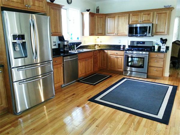 13 Parsons Hill Road Wenham, MA 01984 - Photo 2 of 5 a kitchen with stainless steel appliances granite countertop a refrigerator a stove top oven a sink and dishwasher