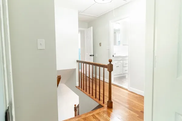 a view of a hallway with wooden floor