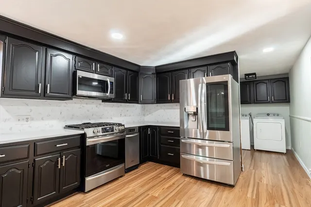 a kitchen with stainless steel appliances and wooden cabinets