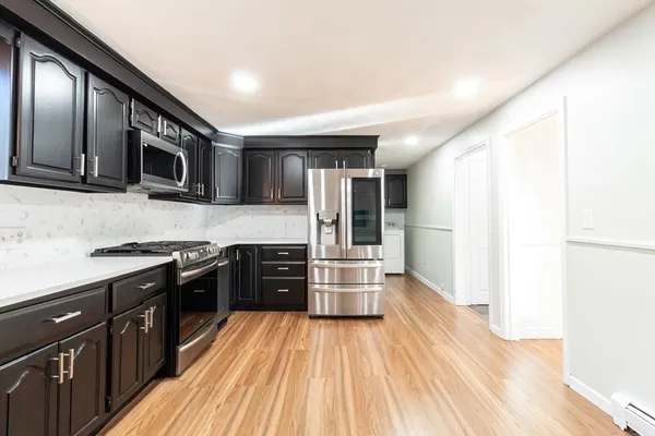 a kitchen with stainless steel appliances and wooden cabinets