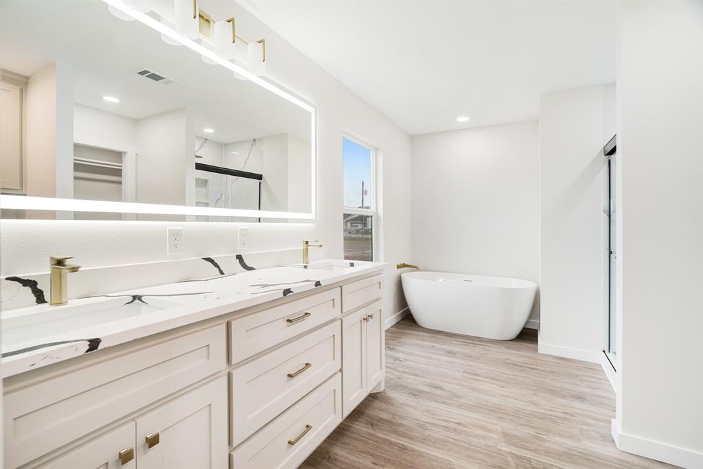 59 Private Road Brookston, TX 75421 - Photo 13 of 26 a spacious bathroom with a double vanity sink mirror and bathtub