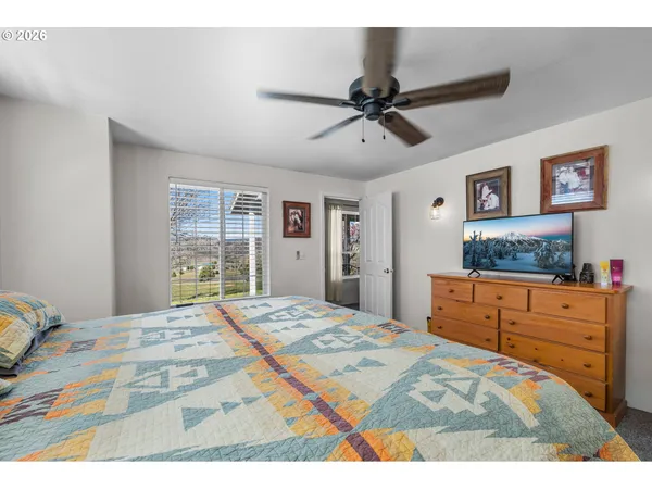 a bedroom with a large bed and a window