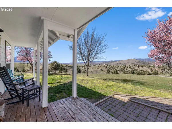 a view of an ocean with a floor to ceiling window and wooden floor