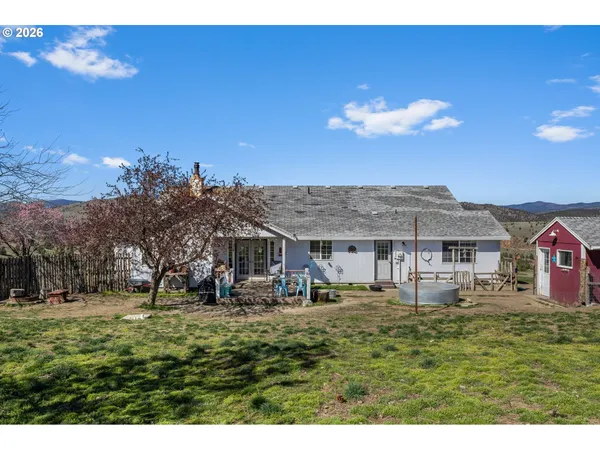 a front view of a building with a garden