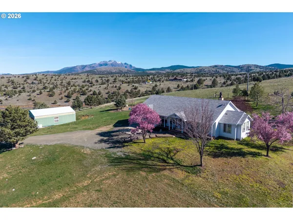 a view of a house with a yard and table