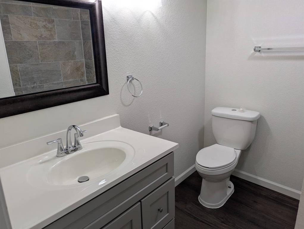 205 North Wood Street Cleburne, TX 76033 - Photo 11 of 15 a bathroom with a sink and a toilet