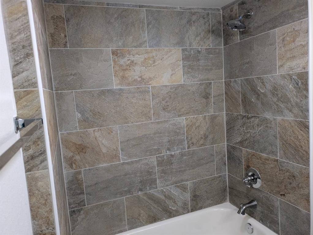 205 North Wood Street Cleburne, TX 76033 - Photo 12 of 15 a bathroom with a shower