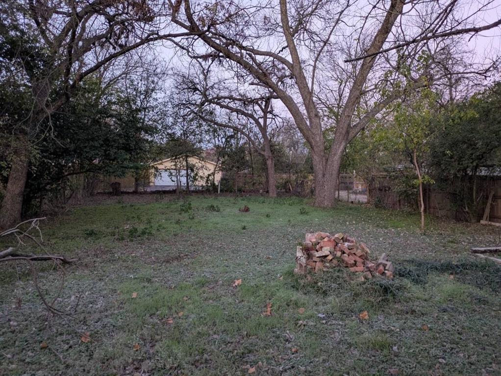 205 North Wood Street Cleburne, TX 76033 - Photo 15 of 15 a backyard of a house with lots of green space