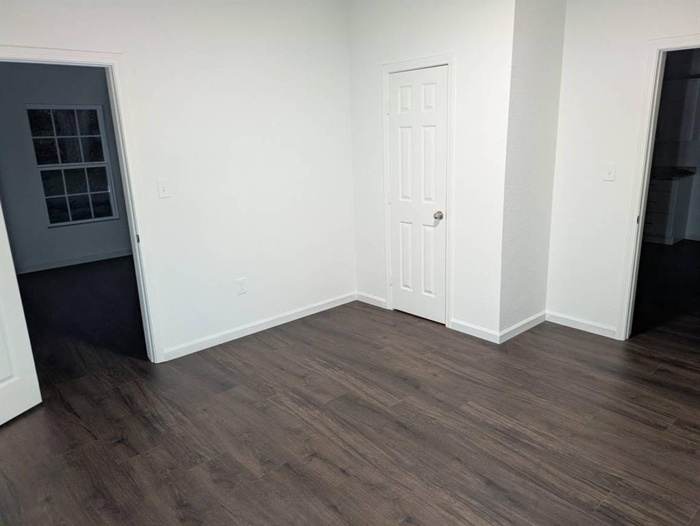 205 North Wood Street Cleburne, TX 76033 - Photo 7 of 15 an empty room with wooden floor and closet