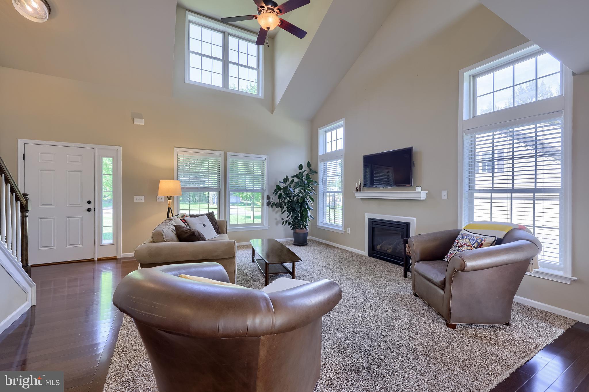 631 Owl Hill Road Lititz, PA 17543 - Photo 6 of 56 a living room with furniture a fireplace and a large window