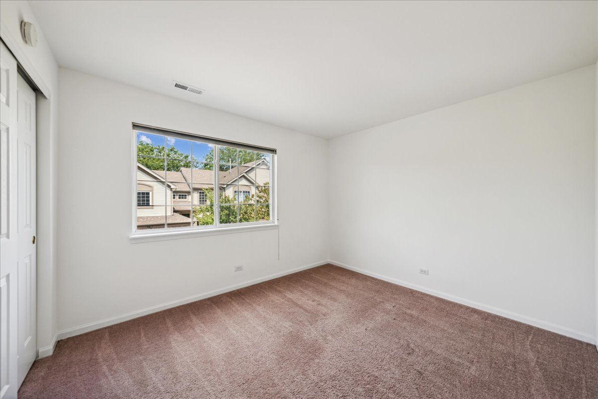 973 Park Hill Circle, Unit 973 Aurora, IL 60502 - Photo 13 of 17 an empty room with windows