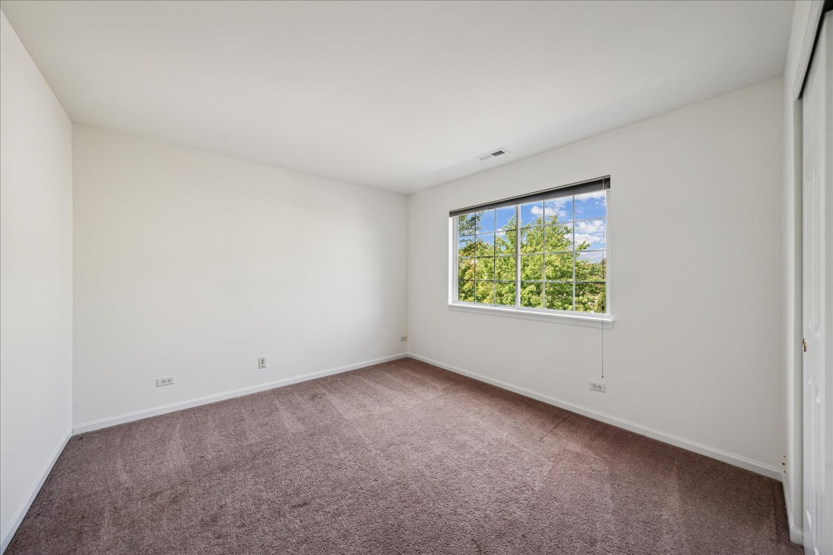973 Park Hill Circle, Unit 973 Aurora, IL 60502 - Photo 14 of 17 an empty room with windows