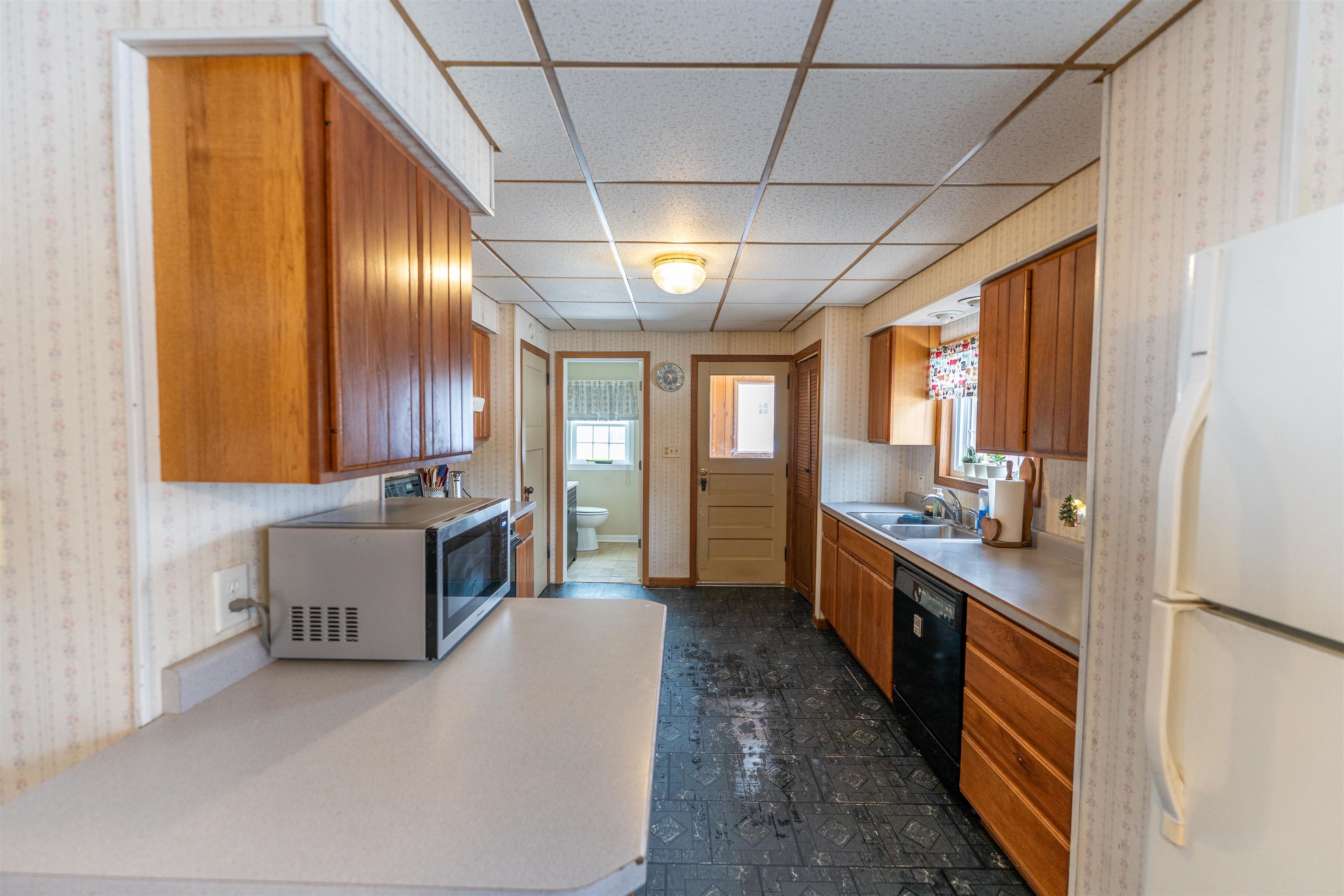7965 North Adeline Road Leaf River, IL 61047 - Photo 11 of 90 a large kitchen with a large window and stainless steel appliances