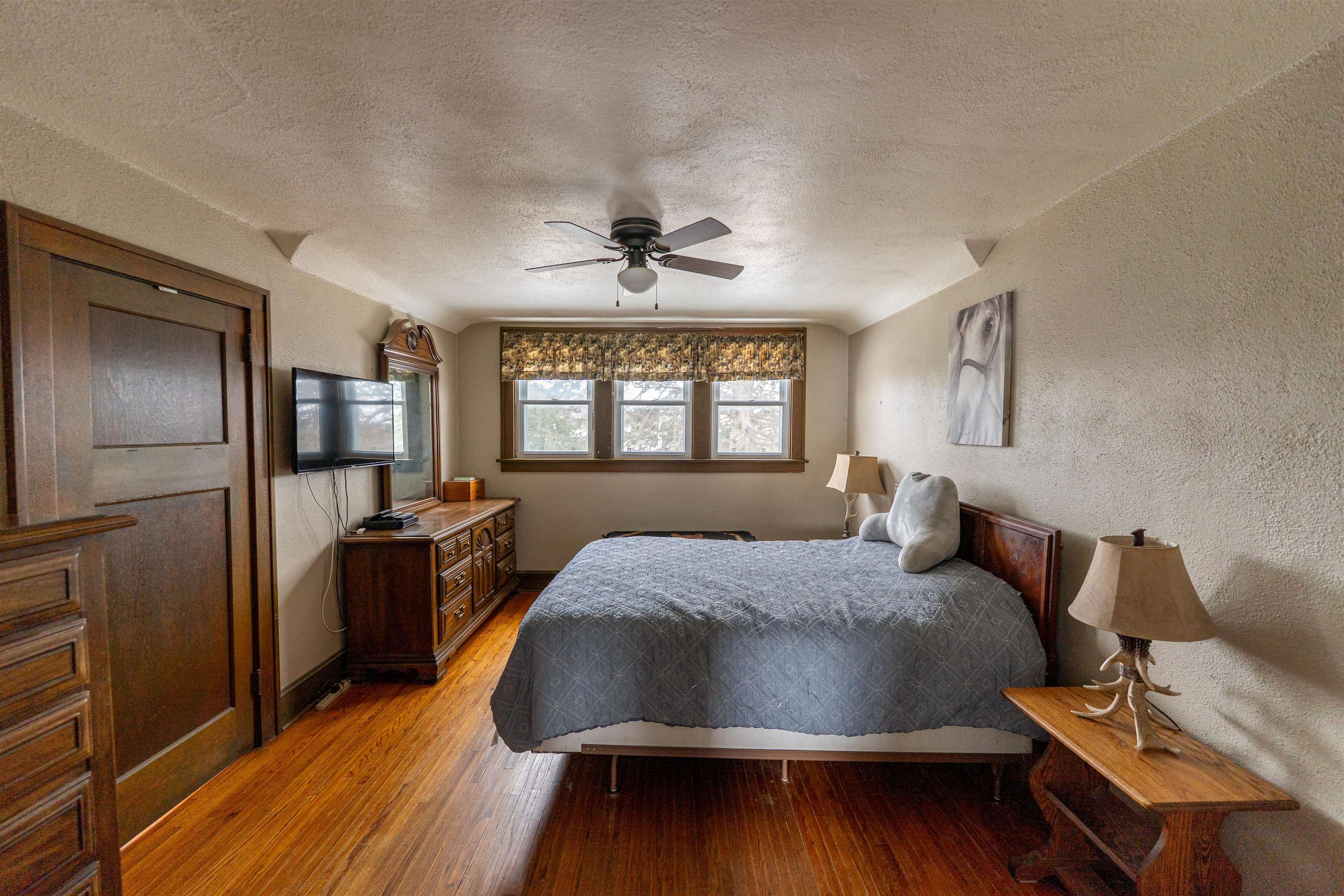 7965 North Adeline Road Leaf River, IL 61047 - Photo 30 of 90 a bed room with a bed and a chandelier