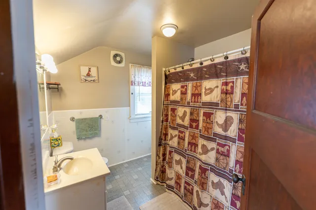 a view of large house with a yard covered in snow