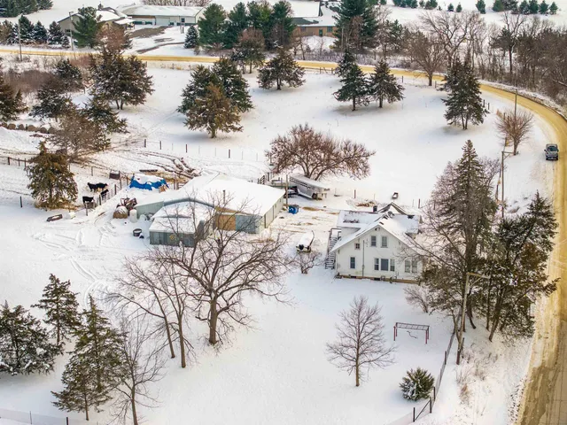 a large kitchen with a window and stainless steel appliances