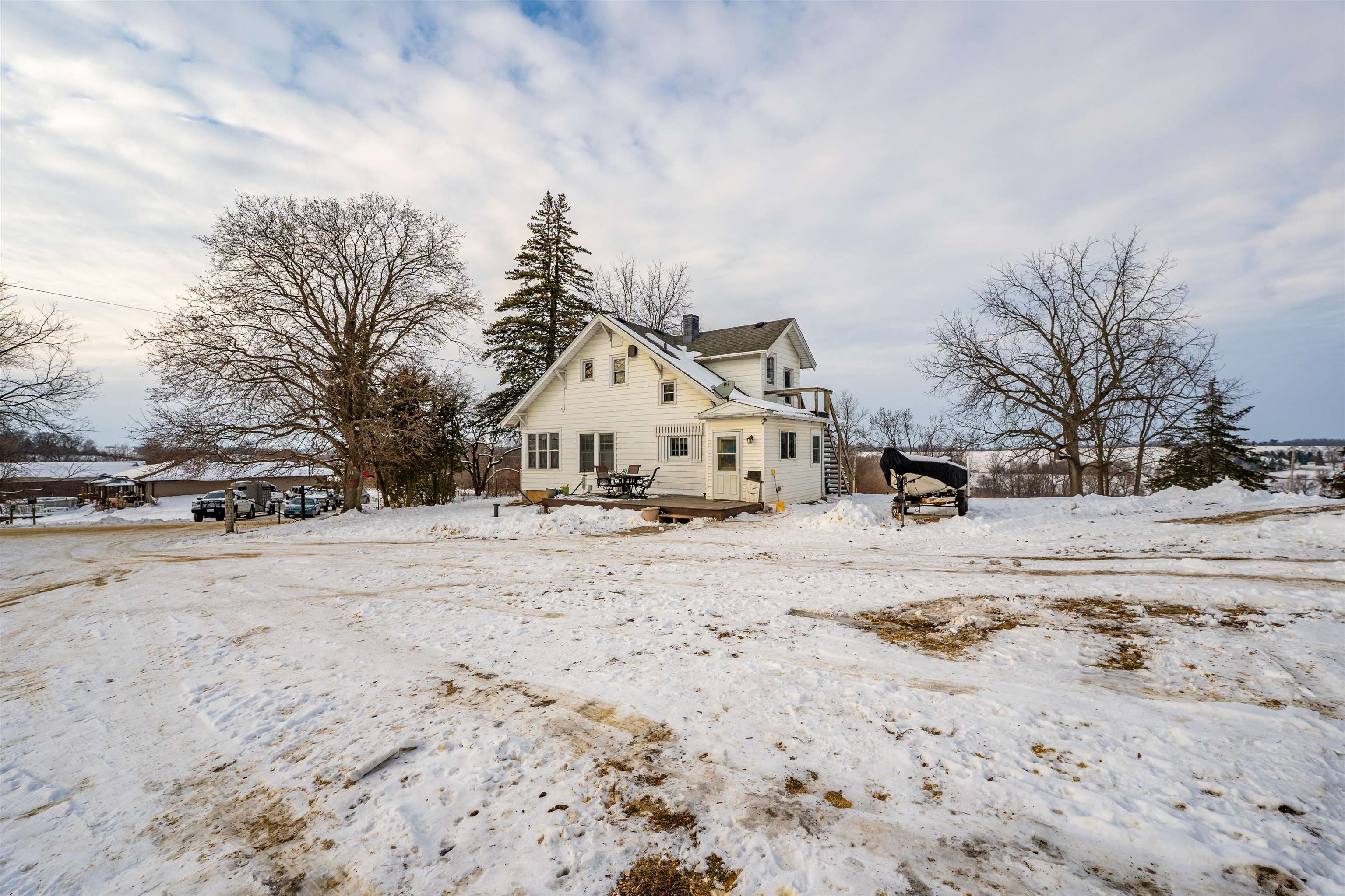 7965 North Adeline Road Leaf River, IL 61047 - Photo 57 of 90 a view of a white house with a snow on the road