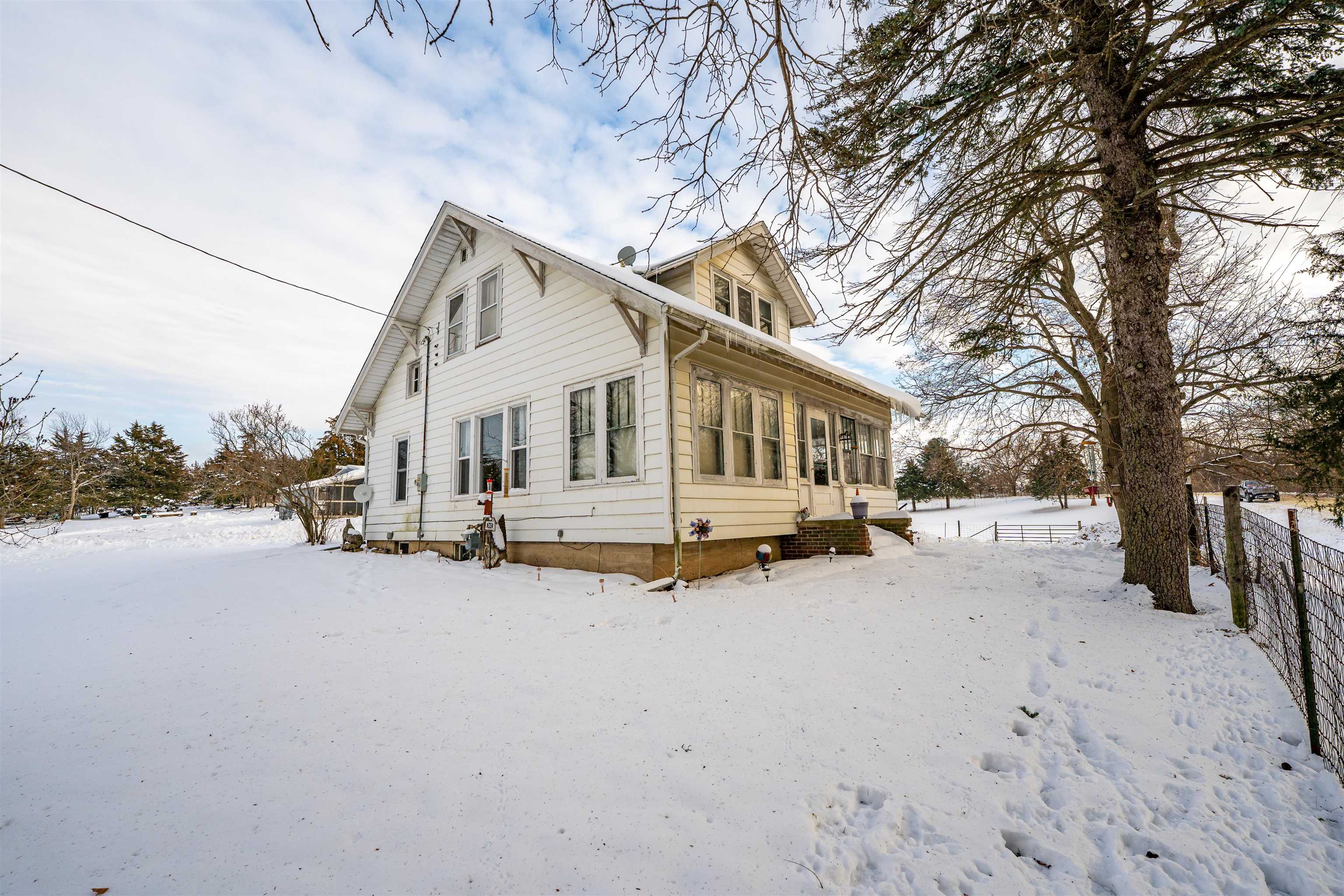 7965 North Adeline Road Leaf River, IL 61047 - Photo 61 of 90 a view of a house with a yard covered in snow