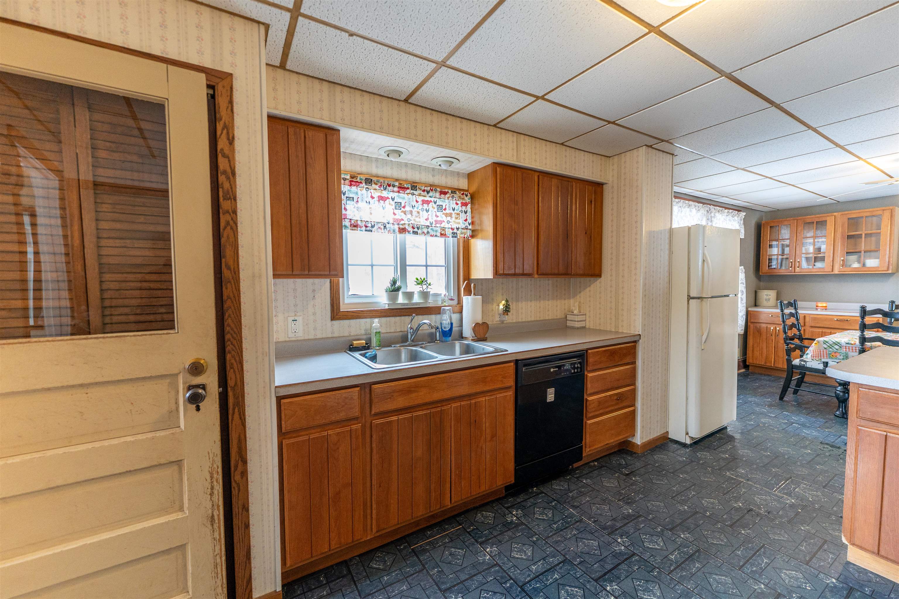 7965 North Adeline Road Leaf River, IL 61047 - Photo 10 of 90 a large kitchen with a window and stainless steel appliances