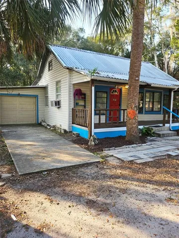 a view of a house with street next to a road