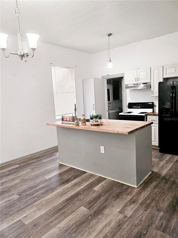 10250 Southeast 108th Terrace Road Ocala, FL 34472 - Photo 5 of 11 a kitchen with stainless steel appliances granite countertop a stove a sink and a refrigerator