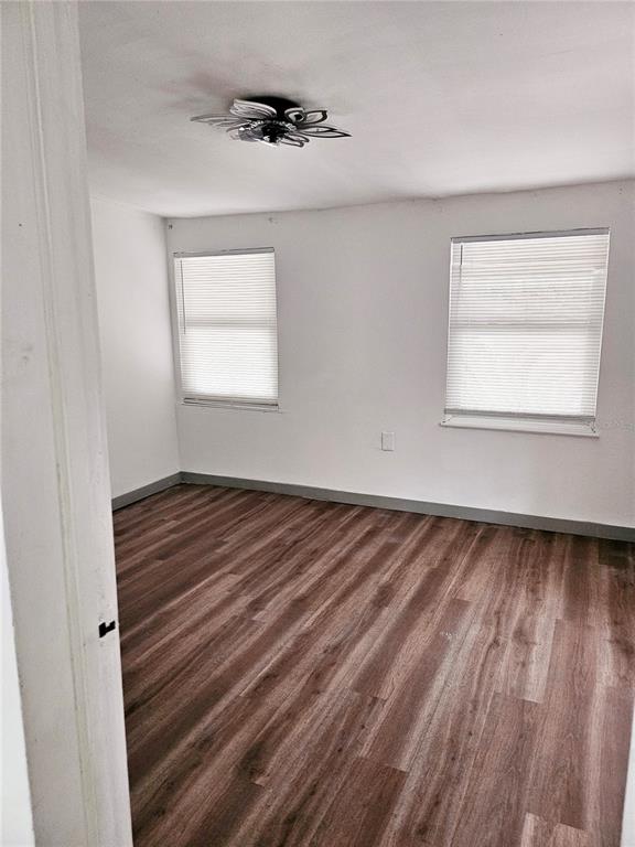 10250 Southeast 108th Terrace Road Ocala, FL 34472 - Photo 7 of 11 a view of an empty room with wooden floor and a window